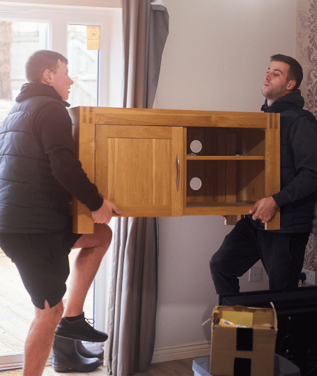 Two removalists removing furniture