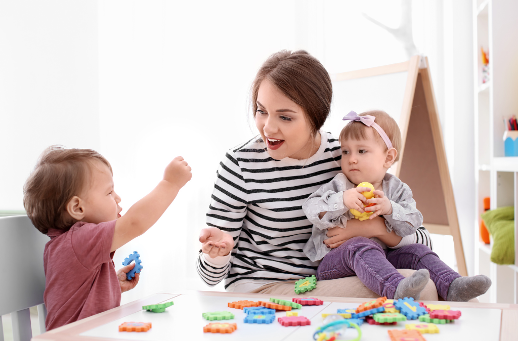 Children engaging in activities with a babysitter