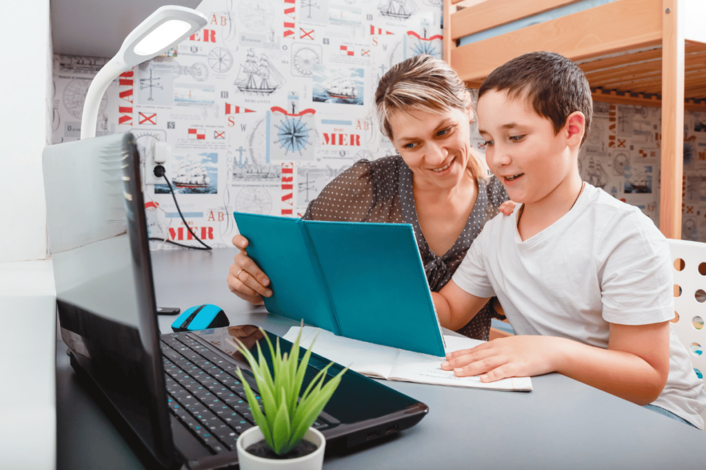 Little boy having lessons with tutor at home. Elementary school tutor