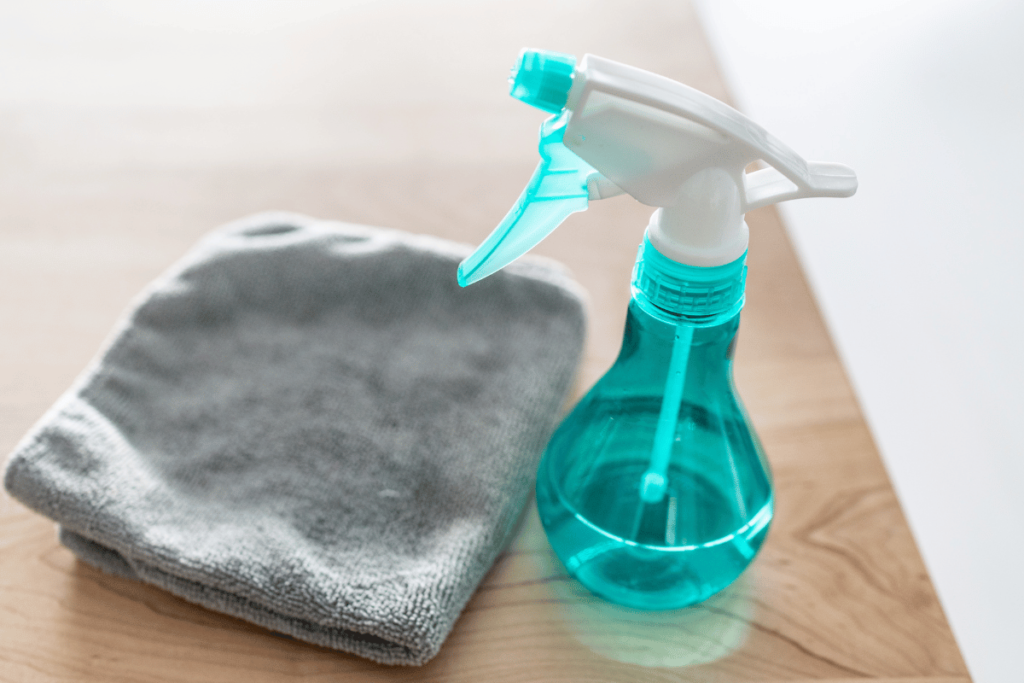 All purpose cleaner disinfectant spray bottle with towel to clean surfaces at home kitchen.