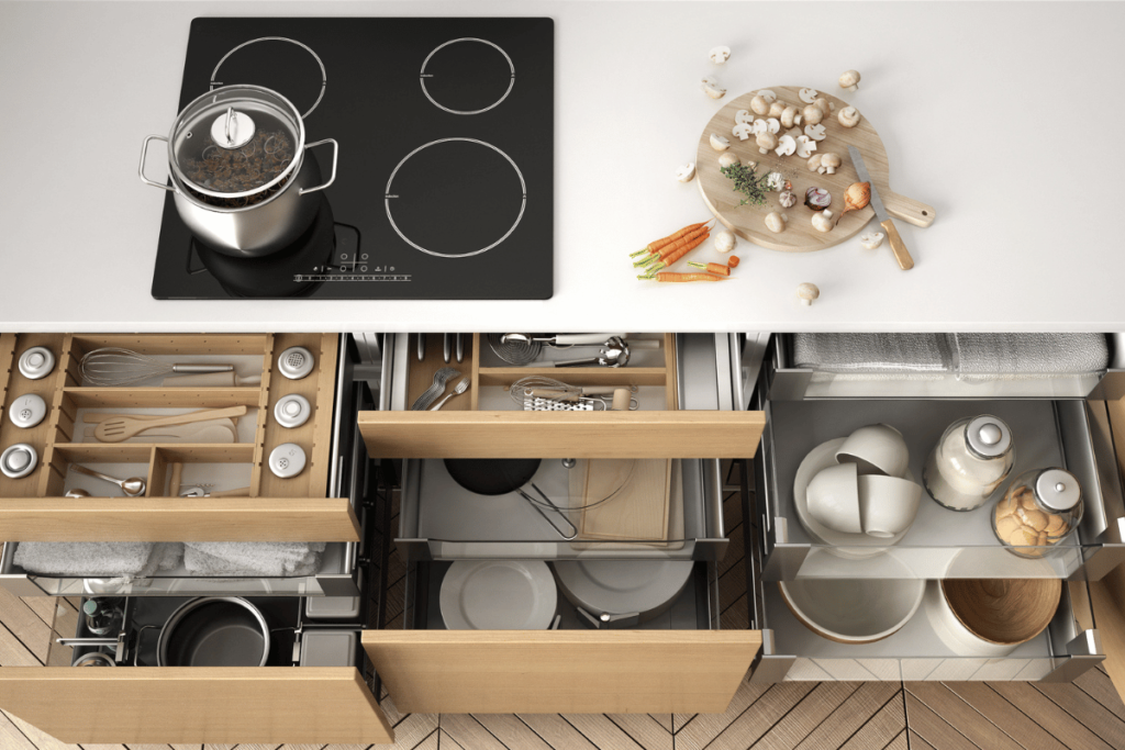 Opened wooden kitchen drawer with accessories inside, solution for kitchen storage and organizing, cooking, modern interior design