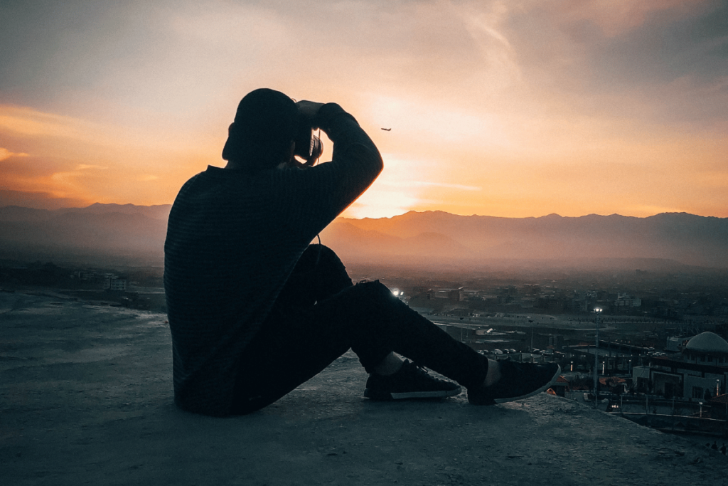 Person Taking Photo During Golden Hour