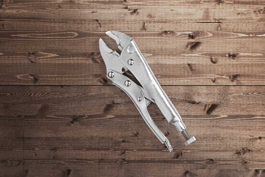 locking plier tool on a wood background