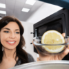 Woman Cleaning Microwave With Lemon