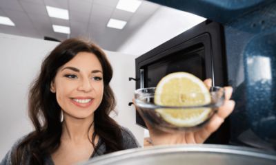 Woman Cleaning Microwave With Lemon