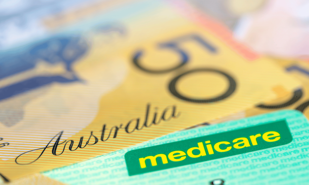 Australian Medicare Card over Money. Shallow focus, with copy space.