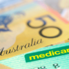 Australian Medicare Card over Money. Shallow focus, with copy space.