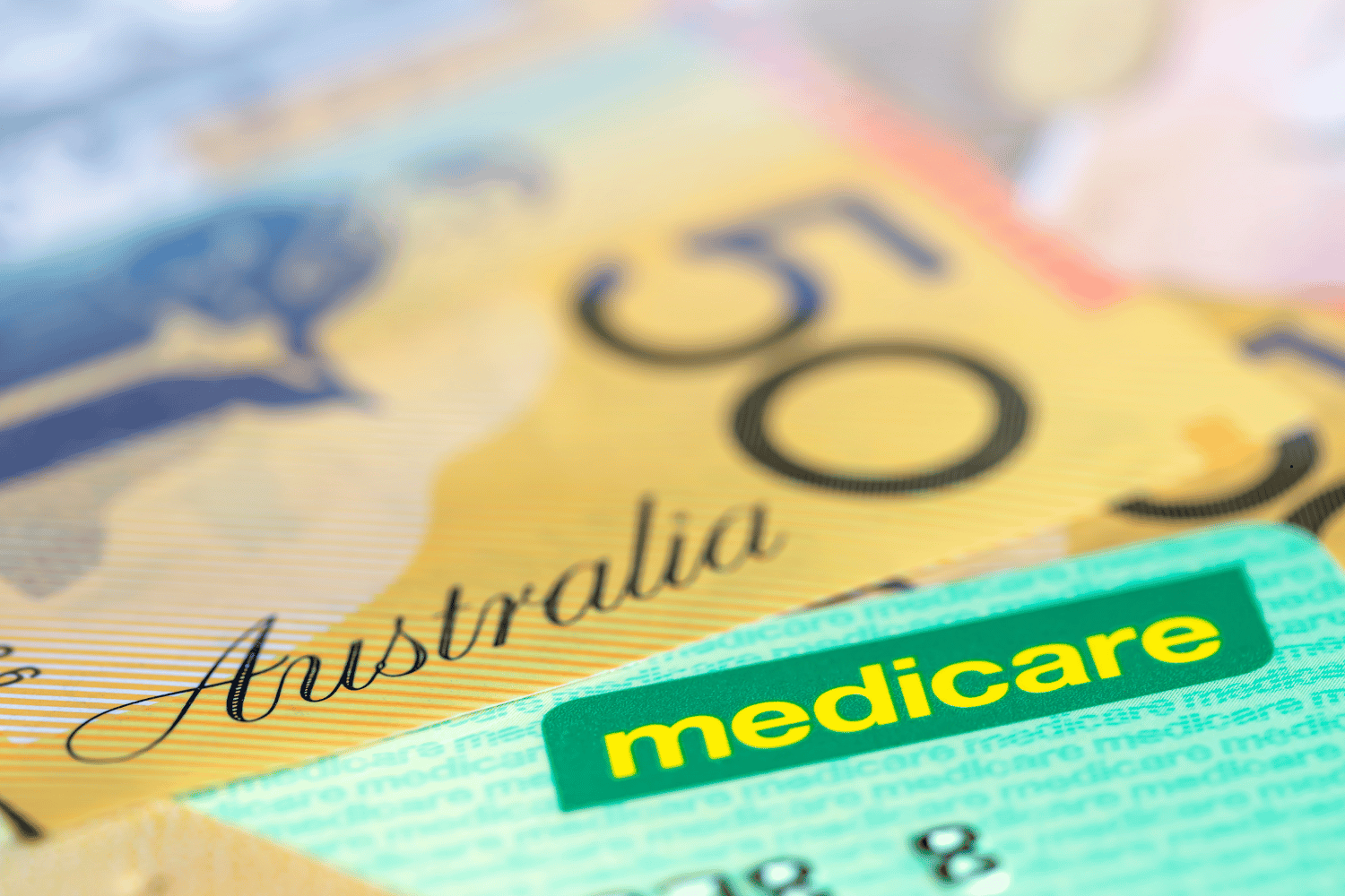 Australian Medicare Card over Money. Shallow focus, with copy space.