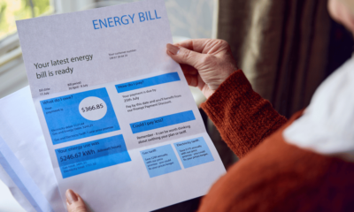 Close up of Senior Woman Opening Energy Bill Concerned about Cost of Living Energy Crisis
