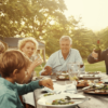 Family enjoying a relaxed outdoor meal together, representing sustainable abundance.