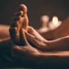 Person pressing the Kidney 1 acupressure point on the sole of the foot to support relaxation before sleep