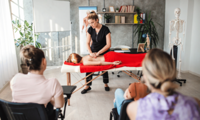 Female massage therapist learning students everything about massage and human body