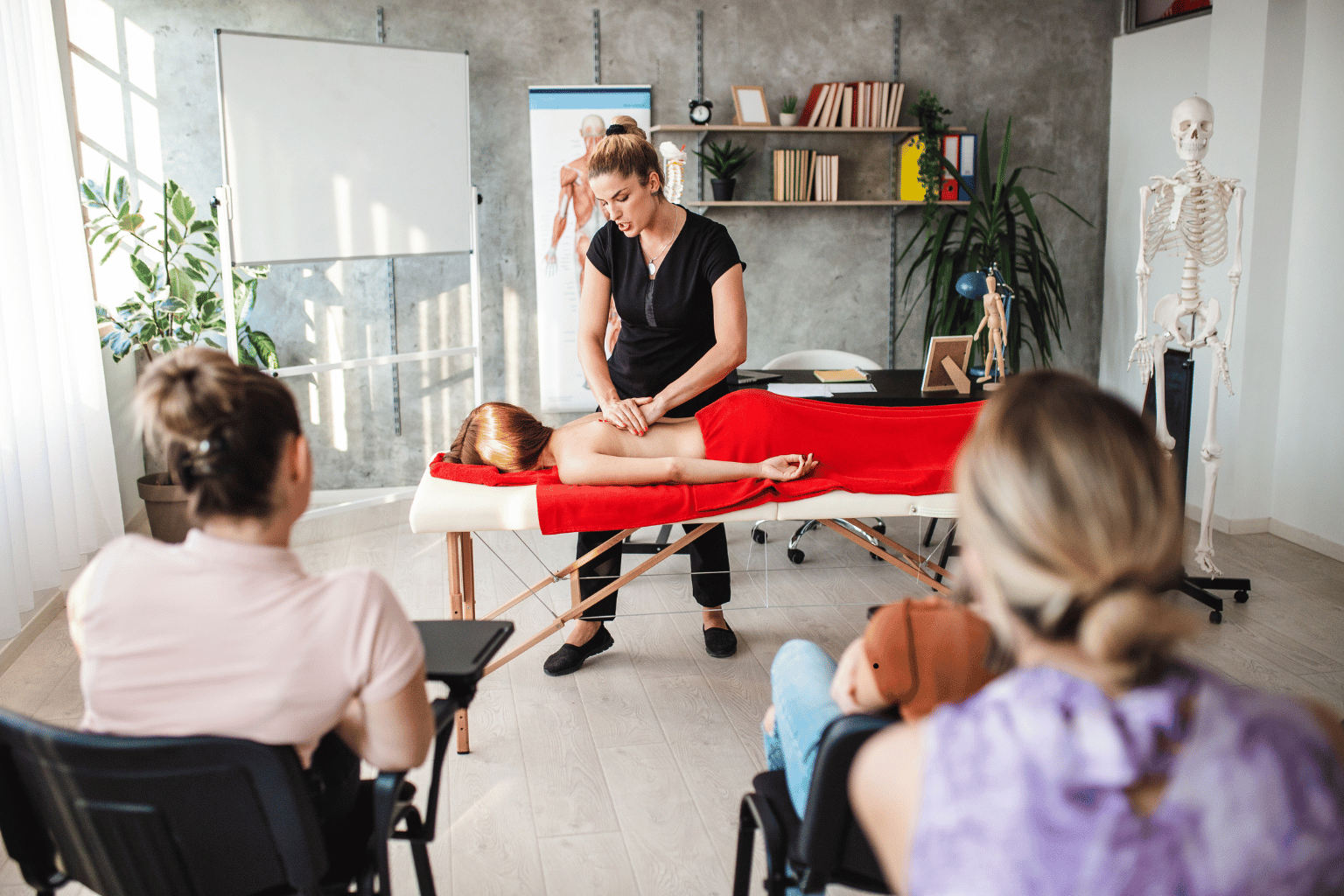 Female massage therapist learning students everything about massage and human body