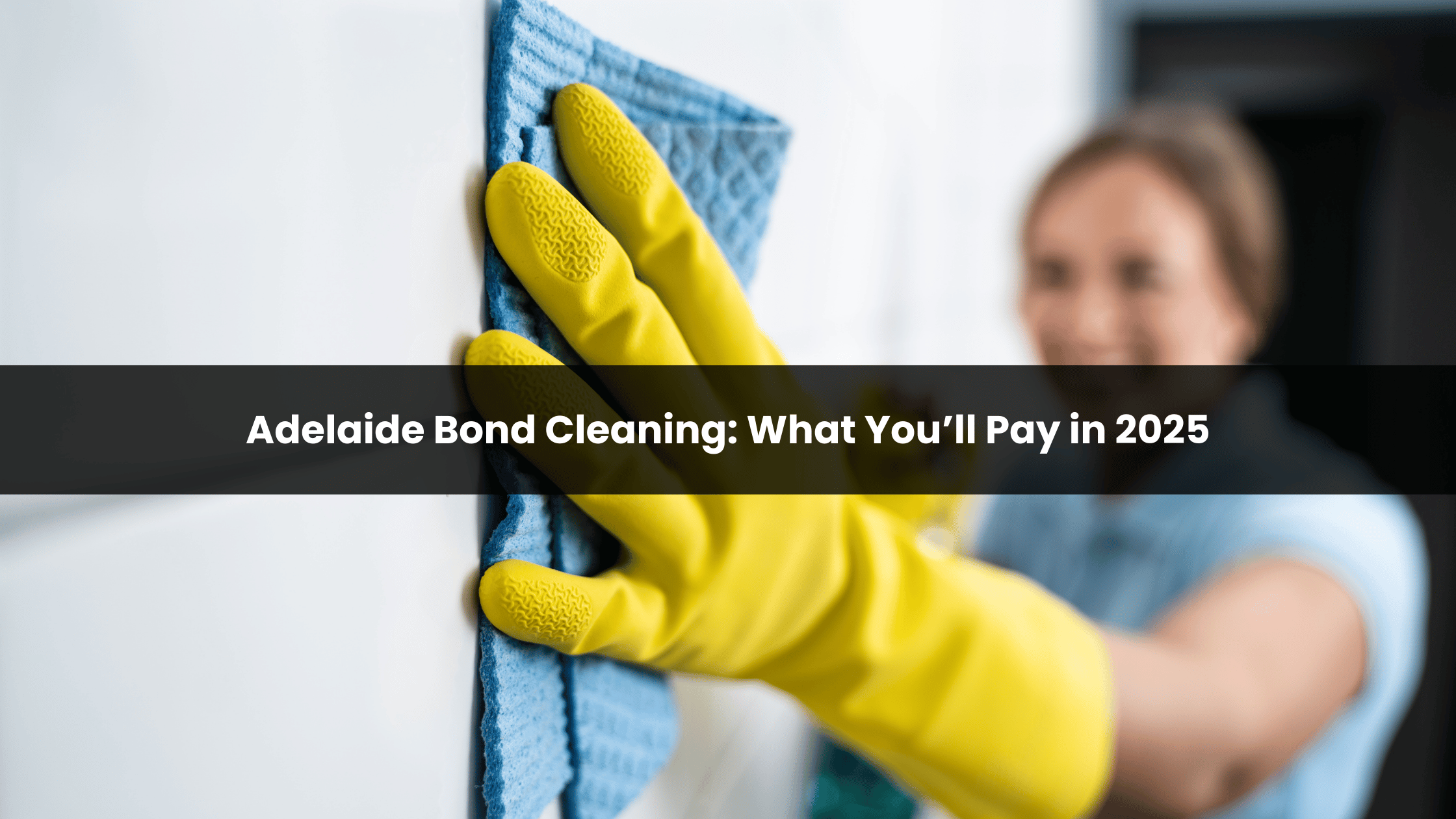 Gloved hand wiping wall with cloth, illustrating end-of-lease cleaning cost in Adelaide for 2025-26.