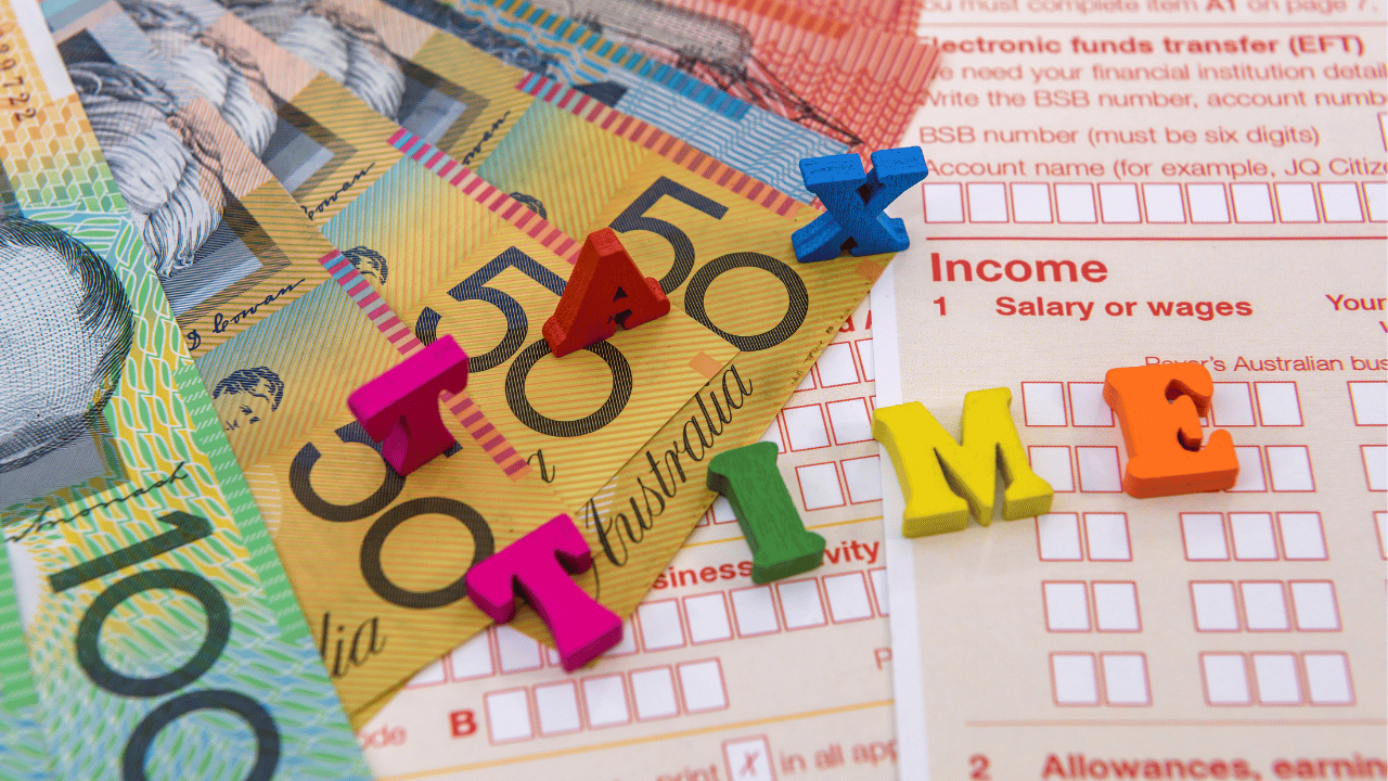 Australian tax forms and banknotes with ‘tax time’ letters, representing small business tax deductions and instant asset write-off.
