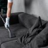 Professional upholstery cleaning of a fabric sofa using extraction equipment