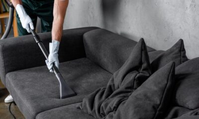 Professional upholstery cleaning of a fabric sofa using extraction equipment