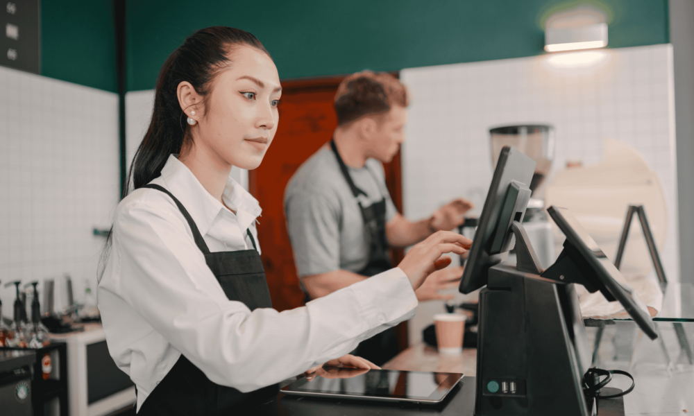 Restaurant staff managing orders on POS system during food delivery operations