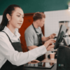 Restaurant staff managing orders on POS system during food delivery operations