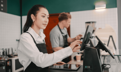 Restaurant staff managing orders on POS system during food delivery operations