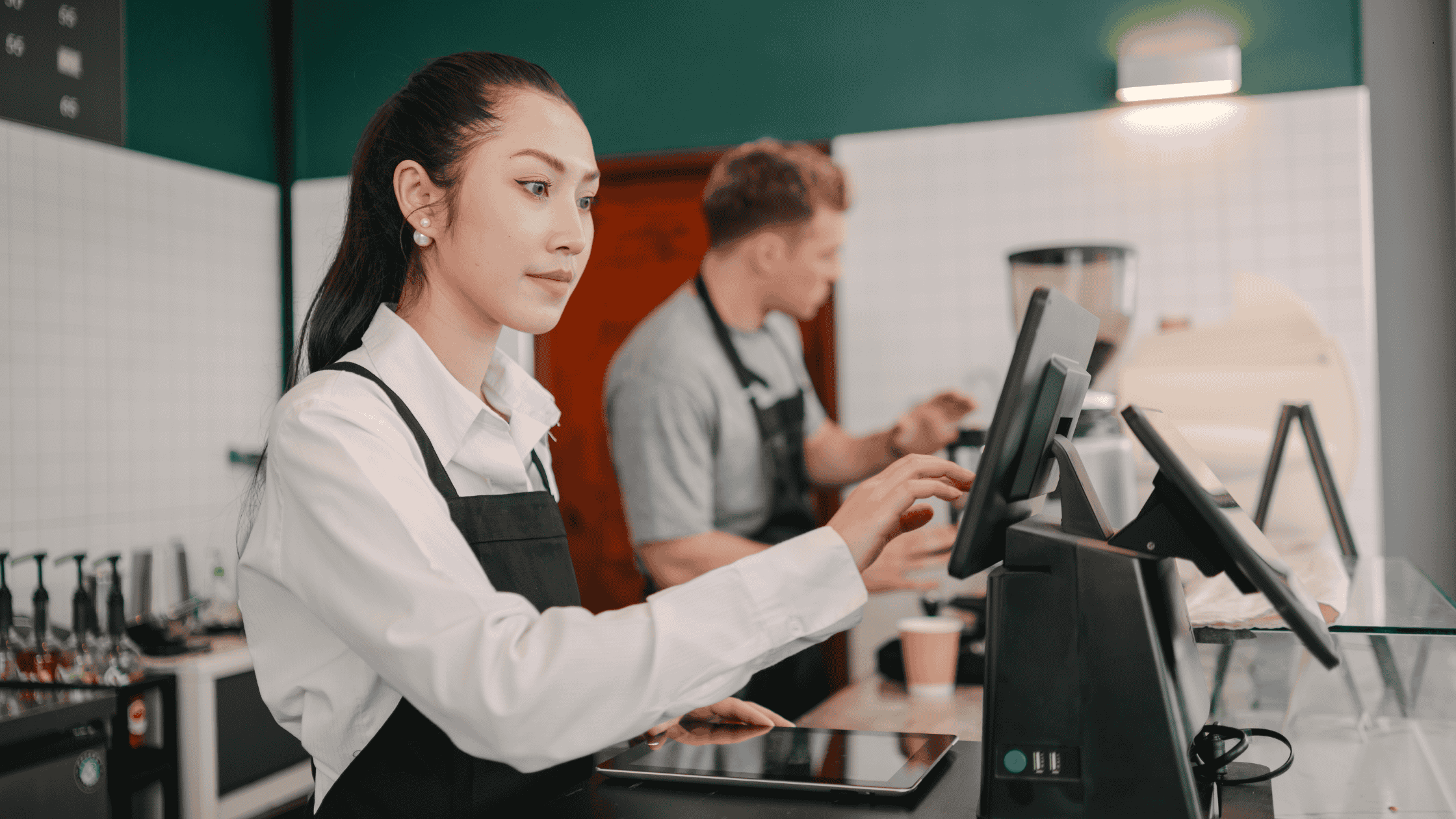 Restaurant staff managing orders on POS system during food delivery operations