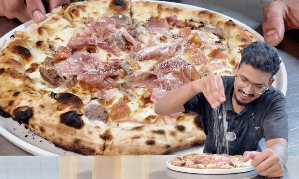 Wood-fired Mandi Mandi pizza from Pizzeria Trieste in Port Lincoln, with a chef seasoning a pizza in the foreground.
